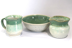 Porcelain mug, bowl, and creamer with Green Tea and Sea Salt glazes.