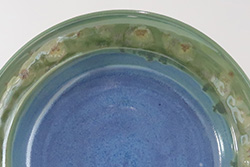 Closeup of Porcelain dish with Texture Blue, Texture Emerald, and Desert Dusk glazes